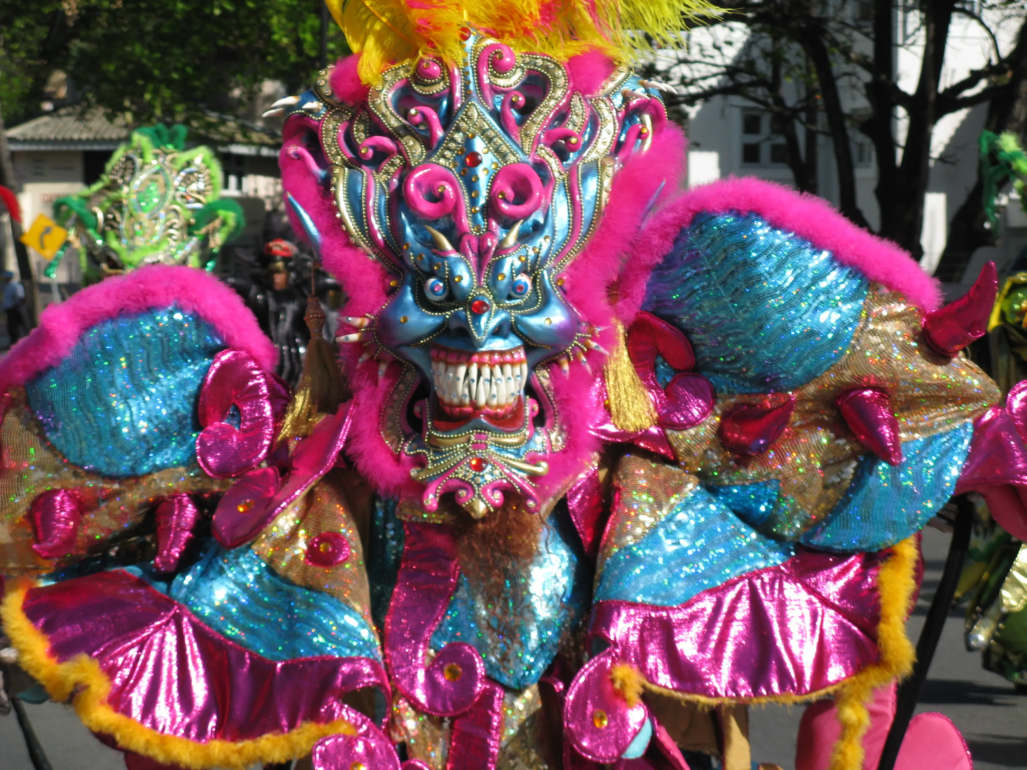 Close-up of an elaborate handcrafted Diablo Cojuelo papier-mâché mask in blue, pink and gold at Carnaval Dominicano