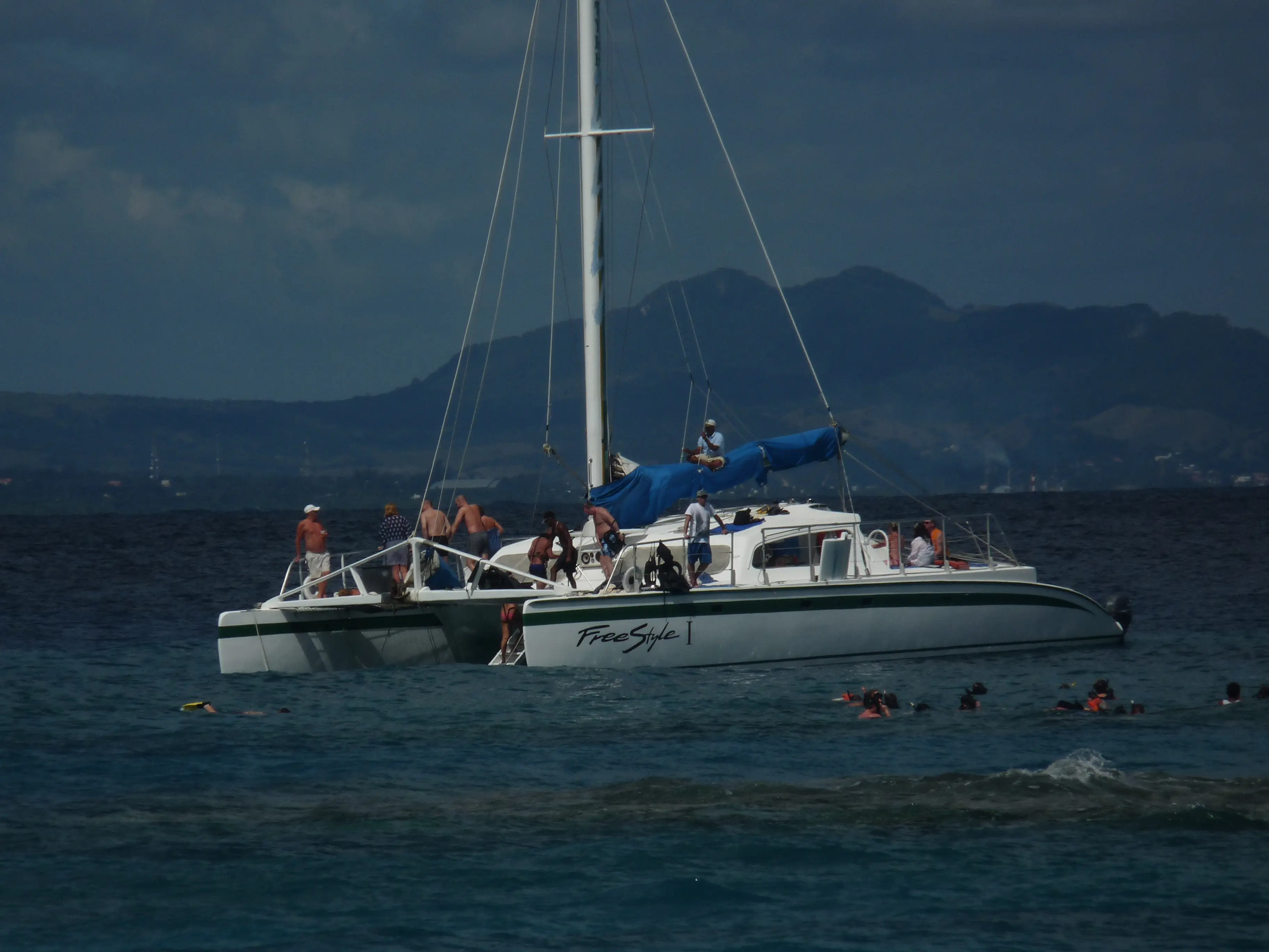 Catamaran anchored off Sosúa with snorkelers in the water