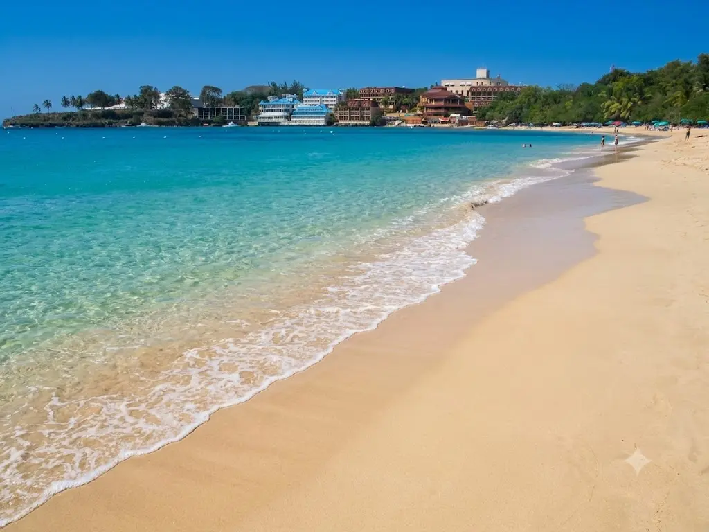 Crystal clear turquoise water and white sand at Sosúa beach bay