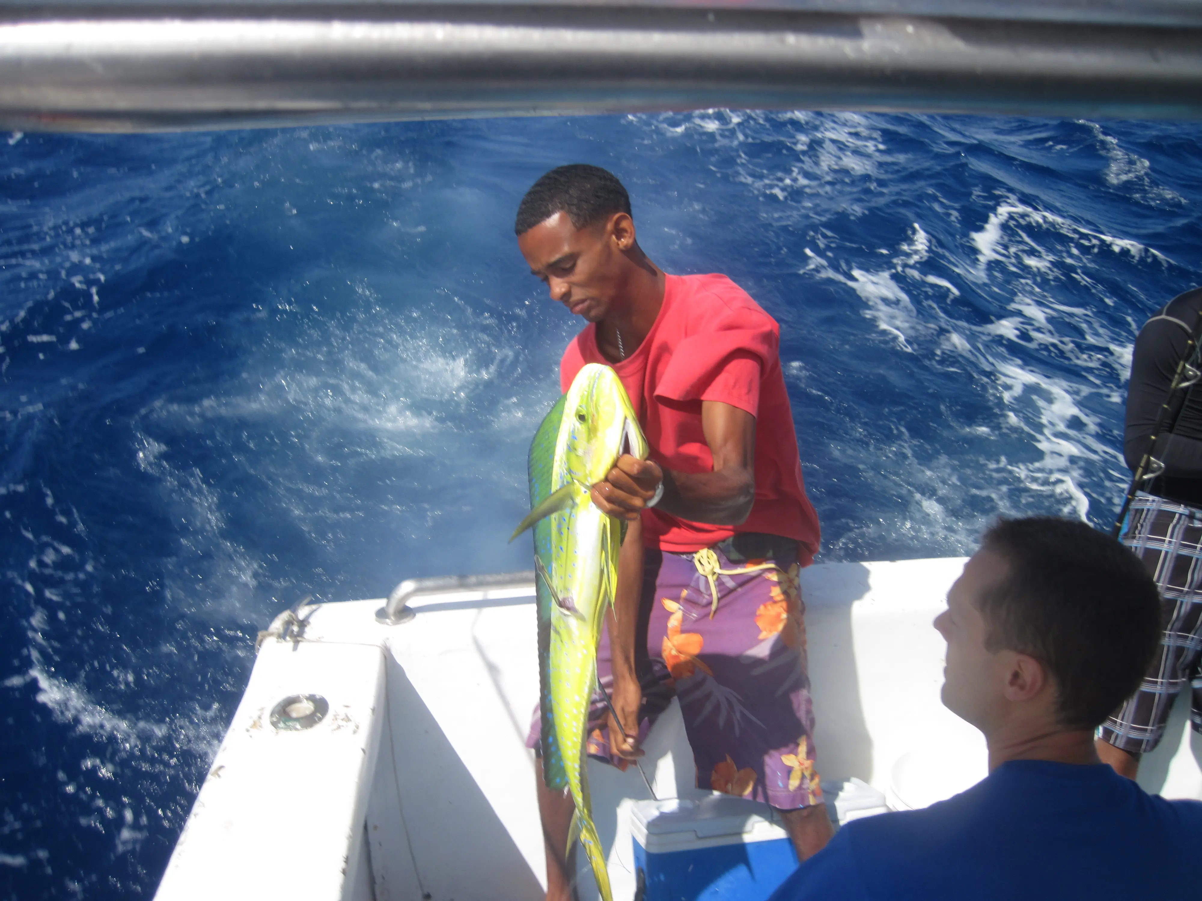Local fishing guide holding a mahi-mahi caught offshore from Sosúa