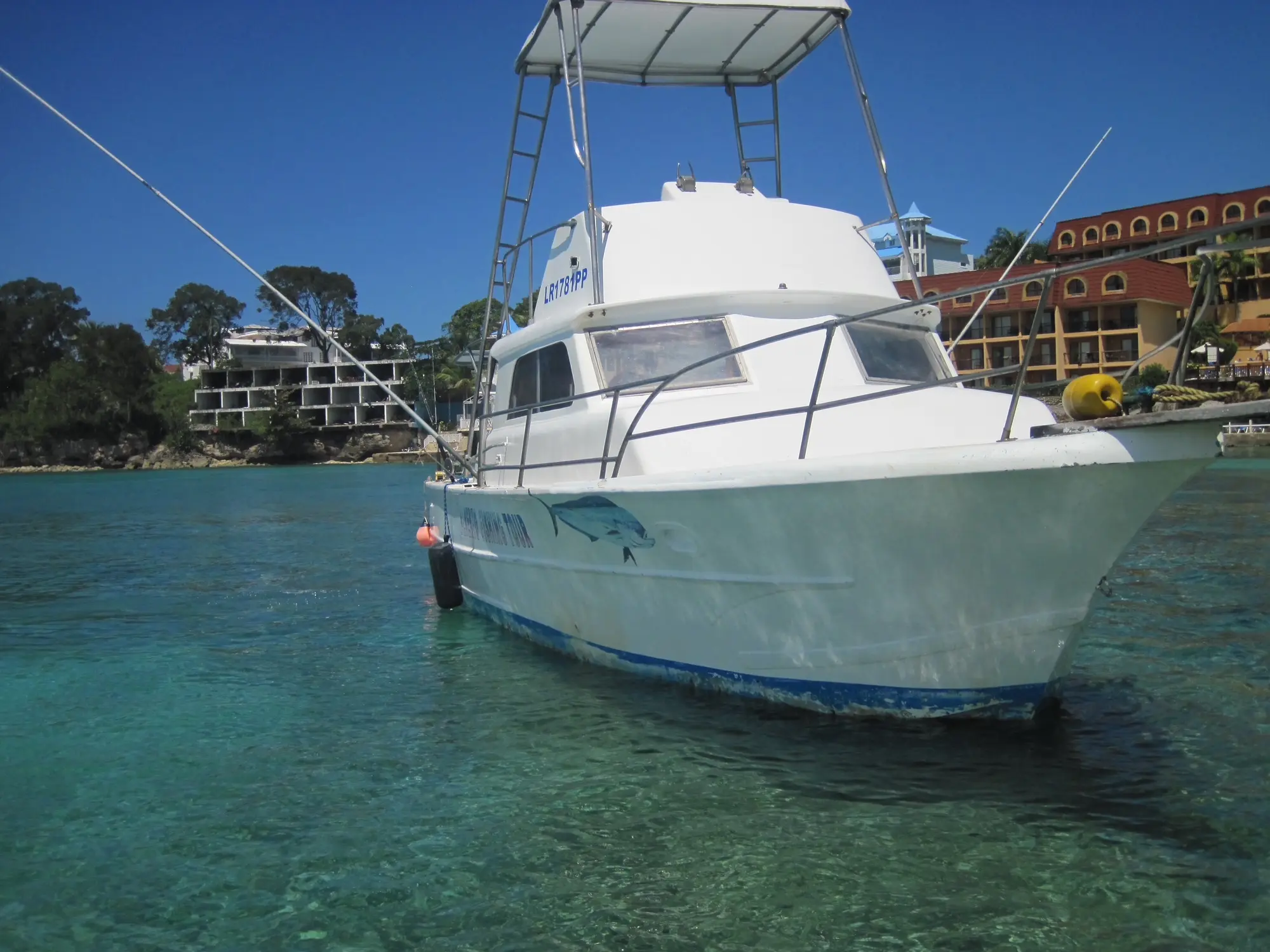 Sport fishing charter boat moored in Sosúa bay with turquoise water