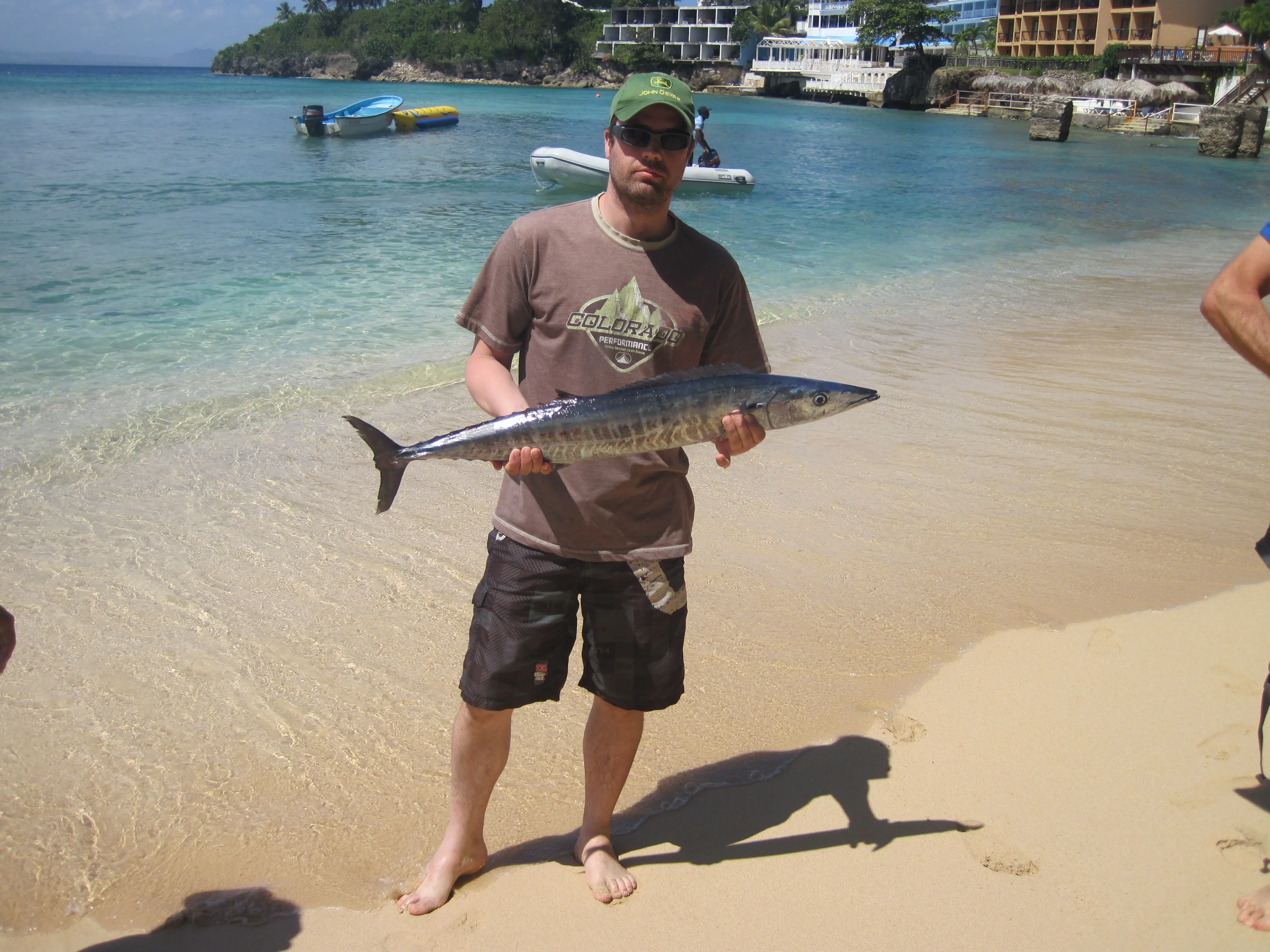 A wahoo caught fishing off the coast of Sosúa, held up on the beach